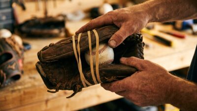 Baseball glove break-in technique with ball and rubber bands