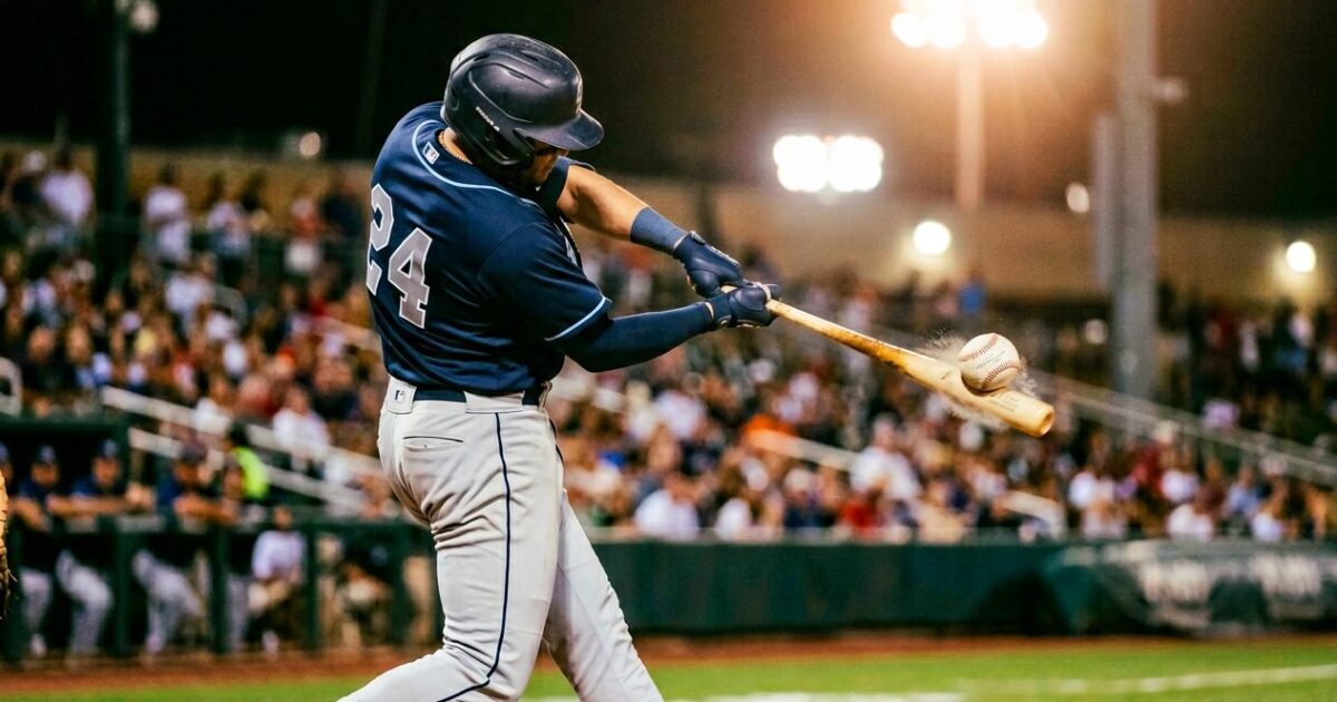 Baseball batter making powerful contact with ball launching off bat